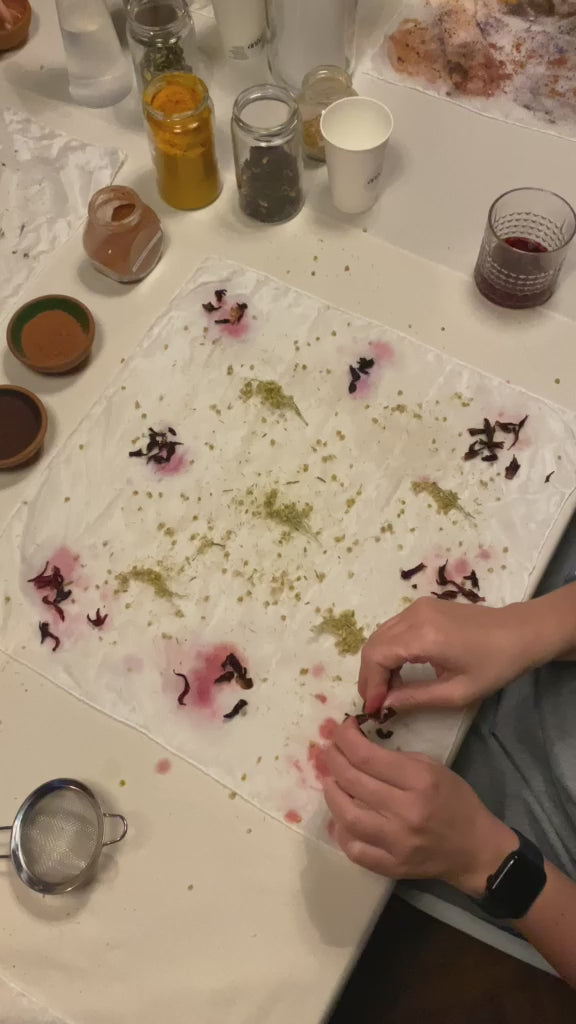 Participants laying dried flowers on silk at Ana Ratković Sobota's workshop